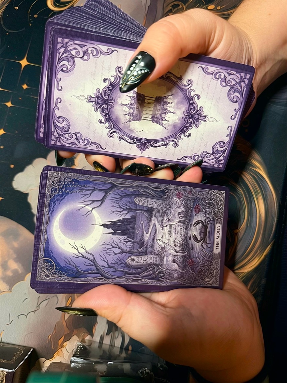 The Moon card from Queen's Folly held beneath the ornate card-back design